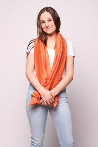 Woman wearing orange colored scarf