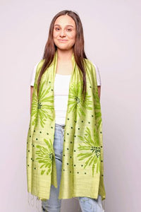 Woman wearing golden lime scarf with green pattern