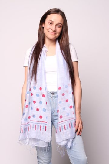 Woman wearing periwinkle scarf with blue and red dots