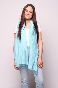 Woman wearing aqua colored scarf