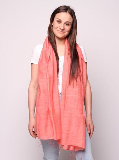 Woman wearing coral colored scarf